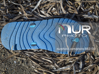 Blue rubber flip-flop found near Skala Sikaminias on the island of Lesbos.  Shoes found on the beaches and around the Greek island where tho...