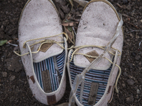 Men's canvas boat shoes found near Skala Sikaminias on the island of Lesbos.  Shoes found on the beaches and around the Greek island where t...