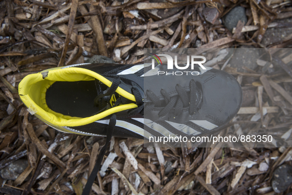 Boy's leather soccer shoe found near Skala Sikaminias on the island of Lesbos.  Shoes found on the beaches and around the Greek island where...