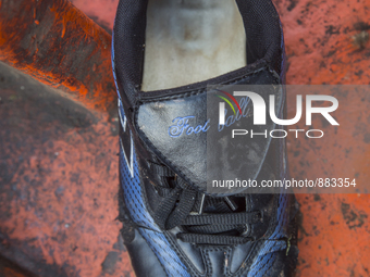 Men's football sneaker found in an abounded boat used by immigrants near Eftalou on the island of Lesbos.  Shoes found on the beaches and ar...