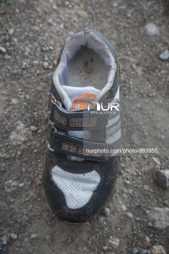 Boys sneaker with velcro closures found near Eftalou on the island of Lesbos.  Shoes found on the beaches and around the Greek island where...