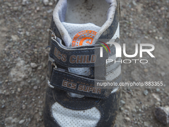 Boys sneaker with velcro closures found near Eftalou on the island of Lesbos.  Shoes found on the beaches and around the Greek island where...