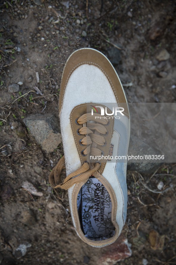 Men's sneaker found near Eftalou on the island of Lesbos.  Shoes found on the beaches and around the Greek island where thousands of immigra...