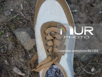 Men's sneaker found near Eftalou on the island of Lesbos.  Shoes found on the beaches and around the Greek island where thousands of immigra...