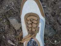 Men's sneaker found near Eftalou on the island of Lesbos.  Shoes found on the beaches and around the Greek island where thousands of immigra...