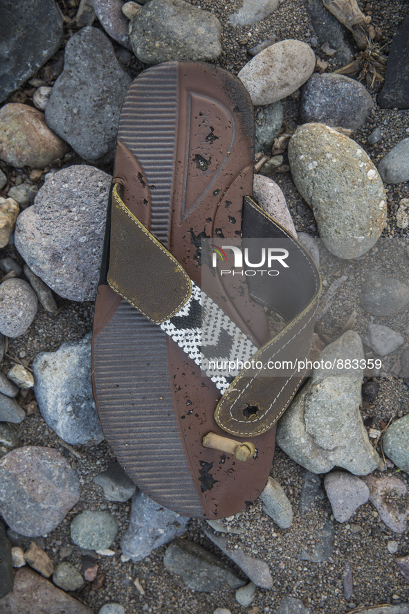 Rubber flipflop with leather and beaded embelishments found near Eftalou on the island of Lesbos.  Shoes found on the beaches and around the...