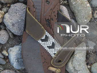 Rubber flipflop with leather and beaded embelishments found near Eftalou on the island of Lesbos.  Shoes found on the beaches and around the...