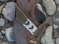 Rubber flipflop with leather and beaded embelishments found near Eftalou on the island of Lesbos.  Shoes found on the beaches and around the...