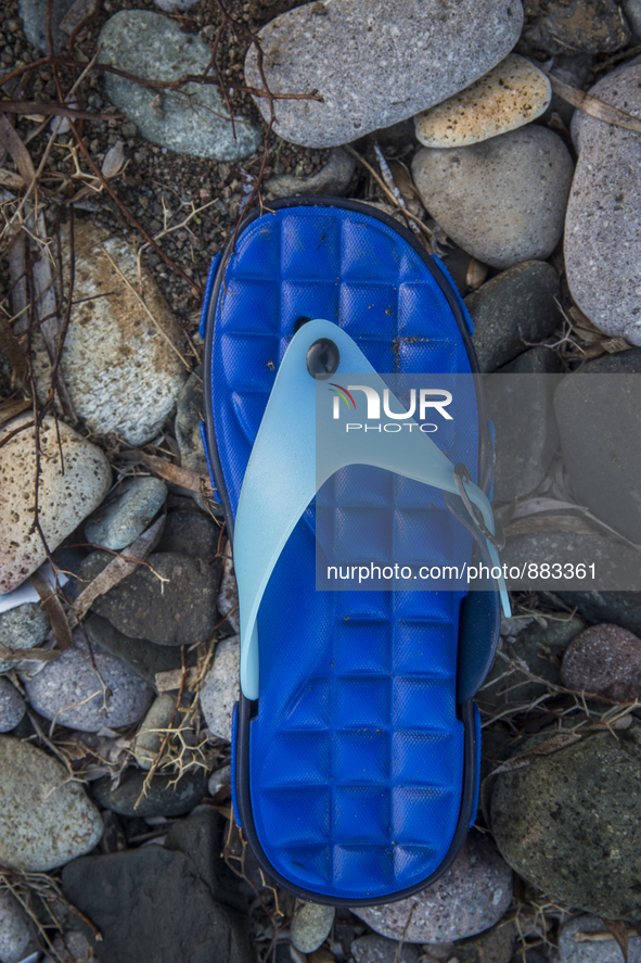 Blue rubber and plastic flipflop found near Eftalou on the island of Lesbos.  Shoes found on the beaches and around the Greek island where t...