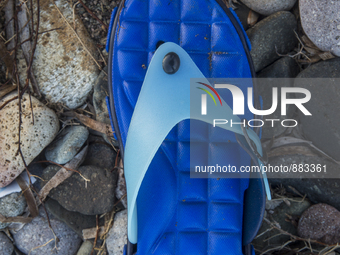 Blue rubber and plastic flipflop found near Eftalou on the island of Lesbos.  Shoes found on the beaches and around the Greek island where t...