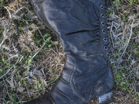 Woman's leather boot, found at the edge of Moria Camp, where immigrants must register with Greek authorities on the island of Lesbos, Greece...