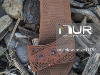 Rubber slipper found near Eftalou on the island of Lesbos.  Shoes found on the beaches and around the Greek island where thousands of immigr...