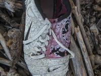 Nike football sneaker found near Eftalou on the island of Lesbos.  Shoes found on the beaches and around the Greek island where thousands of...