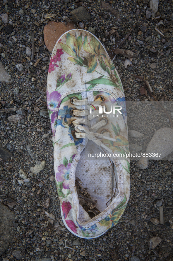 Woman's canvas sneaker with floral pattern found near Eftalou on the island of Lesbos.  Shoes found on the beaches and around the Greek isla...