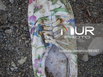 Woman's canvas sneaker with floral pattern found near Eftalou on the island of Lesbos.  Shoes found on the beaches and around the Greek isla...