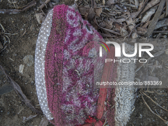 Infant slipper found near Eftalou on the island of Lesbos.  Shoes found on the beaches and around the Greek island where thousands of immigr...