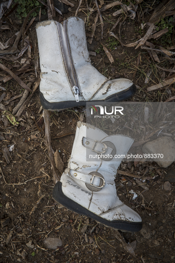 Girl's imitation leather boots with buckles found near Eftalou on the island of Lesbos.  Shoes found on the beaches and around the Greek isl...