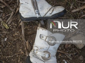 Girl's imitation leather boots with buckles found near Eftalou on the island of Lesbos.  Shoes found on the beaches and around the Greek isl...