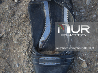 Woman's leather shoe with buckle found near Eftalou on the island of Lesbos.  Shoes found on the beaches and around the Greek island where t...