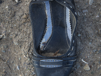 Woman's leather shoe with buckle found near Eftalou on the island of Lesbos.  Shoes found on the beaches and around the Greek island where t...