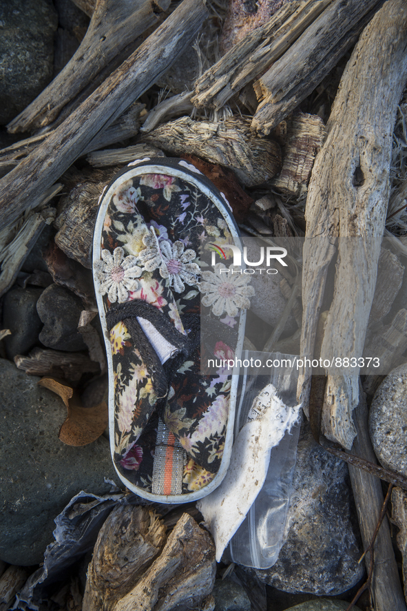 Girl's sneaker with floral designs found near Eftalou on the island of Lesbos.  Shoes found on the beaches and around the Greek island where...