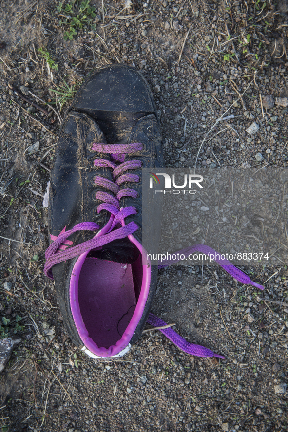 Men's sneaker with purple laces found near Eftalou on the island of Lesbos.  Shoes found on the beaches and around the Greek island where th...