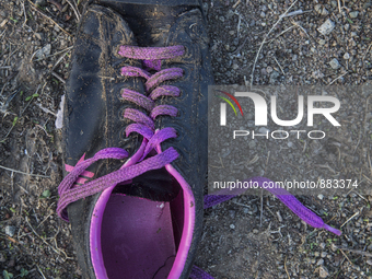 Men's sneaker with purple laces found near Eftalou on the island of Lesbos.  Shoes found on the beaches and around the Greek island where th...