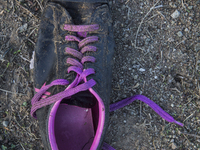 Men's sneaker with purple laces found near Eftalou on the island of Lesbos.  Shoes found on the beaches and around the Greek island where th...