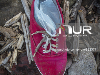 Woman's red canvas with plastic bags inside found near Eftalou on the island of Lesbos.  Shoes found on the beaches and around the Greek isl...