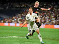 Luka Modric and Xaver Schlager during UEFA Champions League match between Real Madrid and RB Leipzig at Estadio Santiago Bernabeu on Septemb...