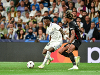 Vinicius Junior and Mohamed Simakan during UEFA Champions League match between Real Madrid and RB Leipzig at Estadio Santiago Bernabeu on Se...