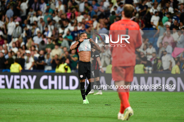 Christopher Nkunku and Thibaut Courtois during UEFA Champions League match between Real Madrid and RB Leipzig at Estadio Santiago Bernabeu o...