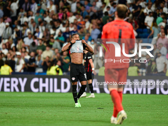 Christopher Nkunku and Thibaut Courtois during UEFA Champions League match between Real Madrid and RB Leipzig at Estadio Santiago Bernabeu o...