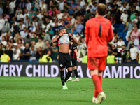 Christopher Nkunku and Thibaut Courtois during UEFA Champions League match between Real Madrid and RB Leipzig at Estadio Santiago Bernabeu o...