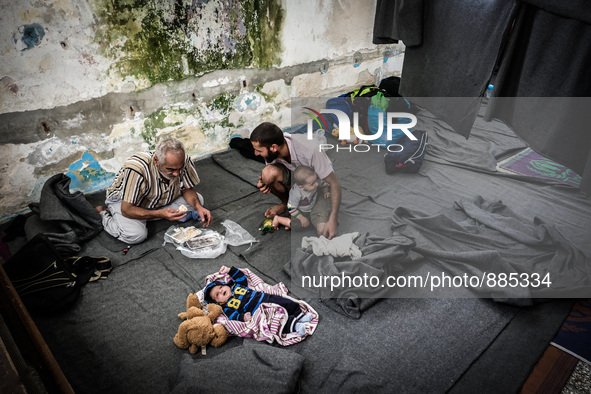 People eat in Leros Refugee Camp, Greece, on October 30, 2015. Refugee camp Leros, located on the Greek Island of Leros is a transit camp fo...