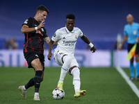 Vinicius Junior left winger of Real Madrid and Brazil and Dominik Szoboszlai attacking midfield of RB Leipzig and Hungary compete for the ba...