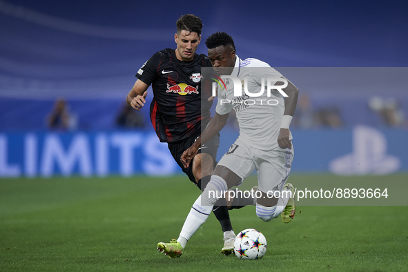 Vinicius Junior left winger of Real Madrid and Brazil and Dominik Szoboszlai attacking midfield of RB Leipzig and Hungary compete for the ba...