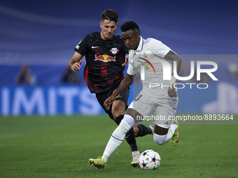 Vinicius Junior left winger of Real Madrid and Brazil and Dominik Szoboszlai attacking midfield of RB Leipzig and Hungary compete for the ba...