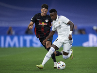 Vinicius Junior left winger of Real Madrid and Brazil and Dominik Szoboszlai attacking midfield of RB Leipzig and Hungary compete for the ba...