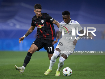 Vinicius Junior left winger of Real Madrid and Brazil and Dominik Szoboszlai attacking midfield of RB Leipzig and Hungary compete for the ba...