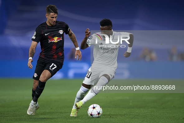 Vinicius Junior left winger of Real Madrid and Brazil and Dominik Szoboszlai attacking midfield of RB Leipzig and Hungary compete for the ba...