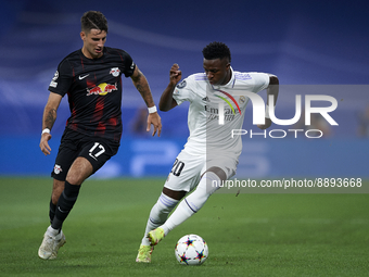 Vinicius Junior left winger of Real Madrid and Brazil and Dominik Szoboszlai attacking midfield of RB Leipzig and Hungary compete for the ba...