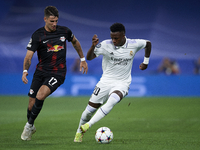 Vinicius Junior left winger of Real Madrid and Brazil and Dominik Szoboszlai attacking midfield of RB Leipzig and Hungary compete for the ba...