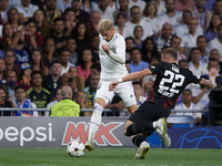 Federico Valverde central midfield of Real Madrid and Uruguay and David Raum left-back of RB Leipzig and Germany compete for the ball during...