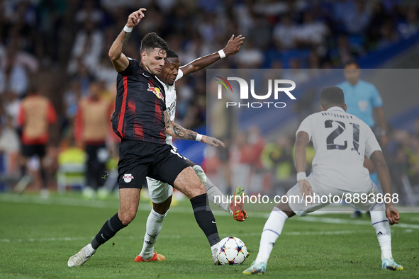 Dominik Szoboszlai attacking midfield of RB Leipzig and Hungary and David Alaba centre-back of Real Madrid and Austria compete for the ball...