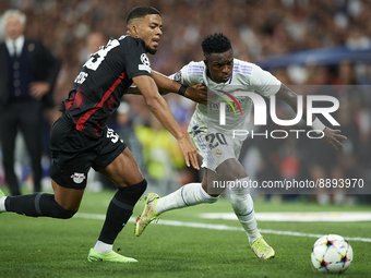 Vinicius Junior left winger of Real Madrid and Brazil and Benjamin Henrichs right-back of RB Leipzig and Germany compete for the ball during...