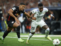 Vinicius Junior left winger of Real Madrid and Brazil and Benjamin Henrichs right-back of RB Leipzig and Germany compete for the ball during...