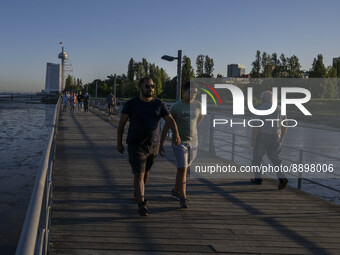 People are seen walking around the walkway of the Vasco da Gama bridge, Lisbon. September 22, 2022. (