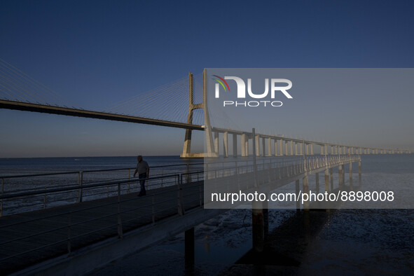 A person is seen walking around the walkway of the Vasco da Gama bridge, Lisbon. September 22, 2022. 