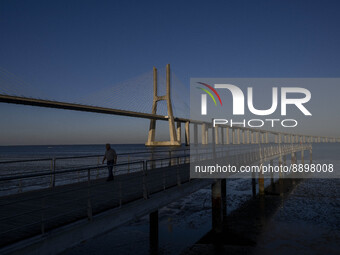 A person is seen walking around the walkway of the Vasco da Gama bridge, Lisbon. September 22, 2022. (